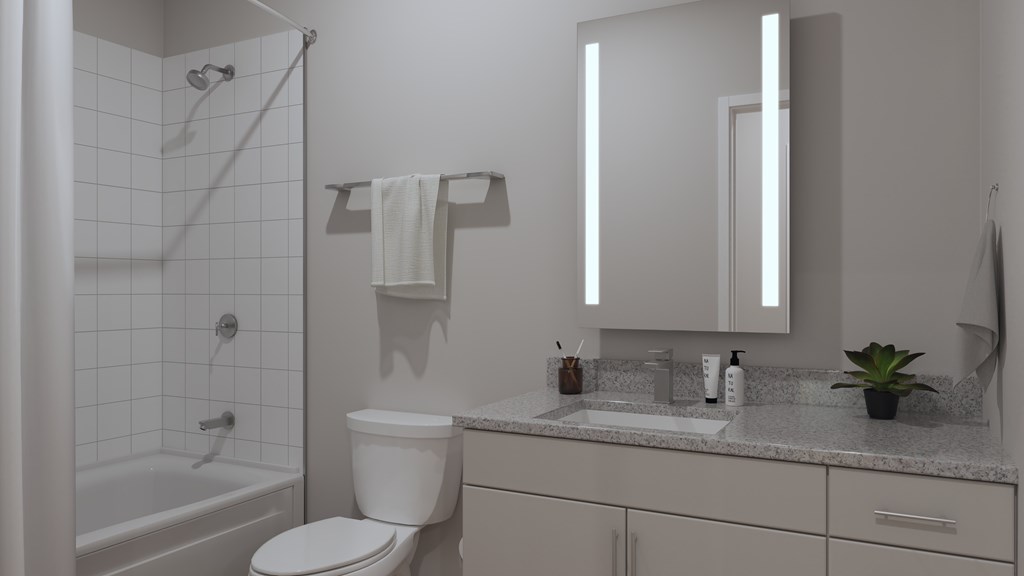 A white bathroom with a toilet, sink, and bathtub.