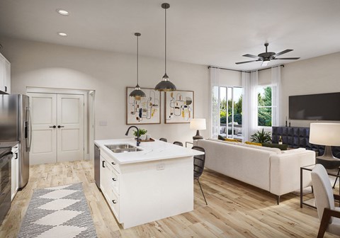 a kitchen and living room with white cabinets and a white counter top