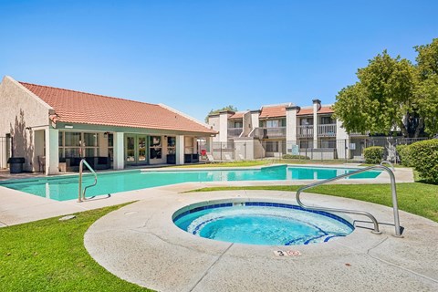 A swimming pool with a hot tub in the middle of it.