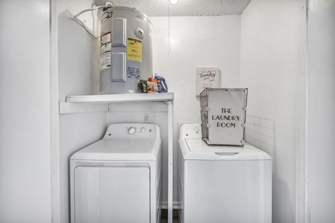 A small laundry room with a washer and dryer.