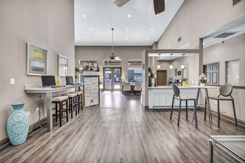 A modern kitchen with a dining area and a blue vase on the floor.