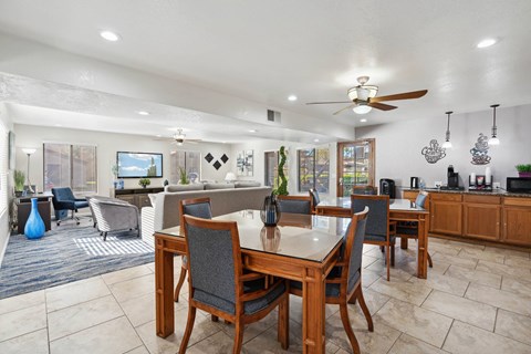 A dining room with a table and chairs.