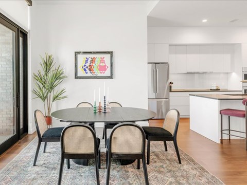 A modern dining room with a round table and chairs.