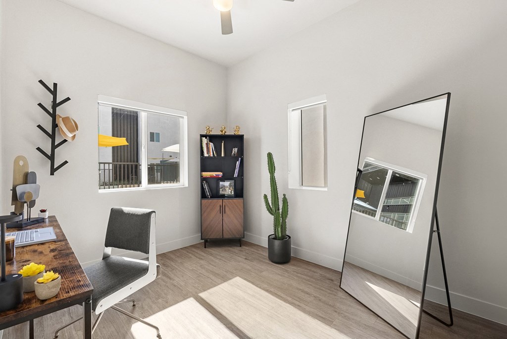 the living room of a studio apartment with a mirror and a desk at SECOND AVE COMMONS | BRAND-NEW, Mesa