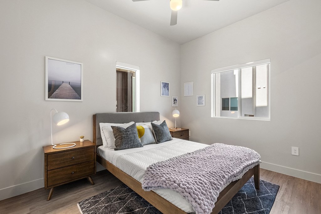 a bedroom with a bed and two windows a bedroom with a bed and two windows at SECOND AVE COMMONS | BRAND-NEW, Arizona