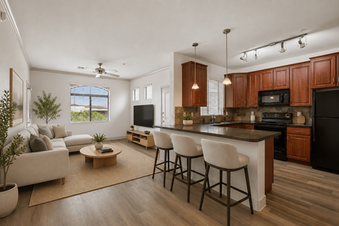 A modern kitchen with dark wood cabinets and a black refrigerator.