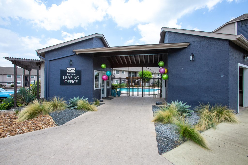 A blue building with a sign that says Leasing Office.