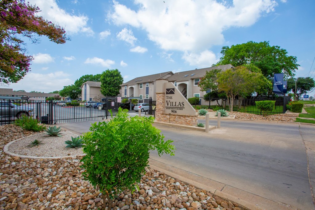 A sign that says "The Villas" is in front of a building.