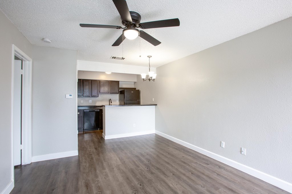 A room with a ceiling fan and light fixture.