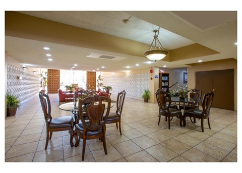 A dining room with a table set for six.