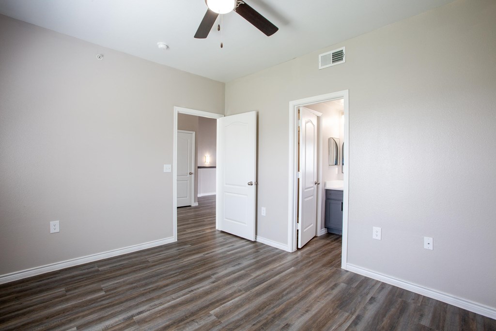 A room with a ceiling fan and light fixture.