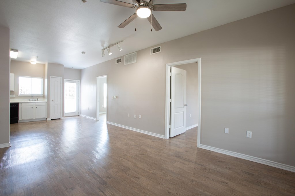 A room with a ceiling fan and light fixture.
