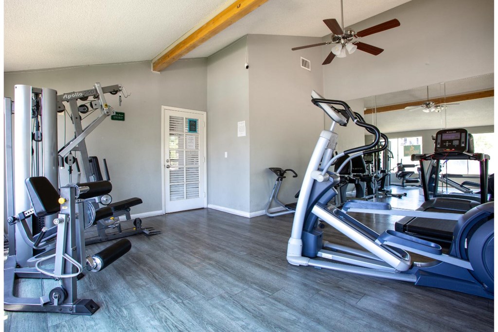 A spacious home gym with a variety of exercise equipment.