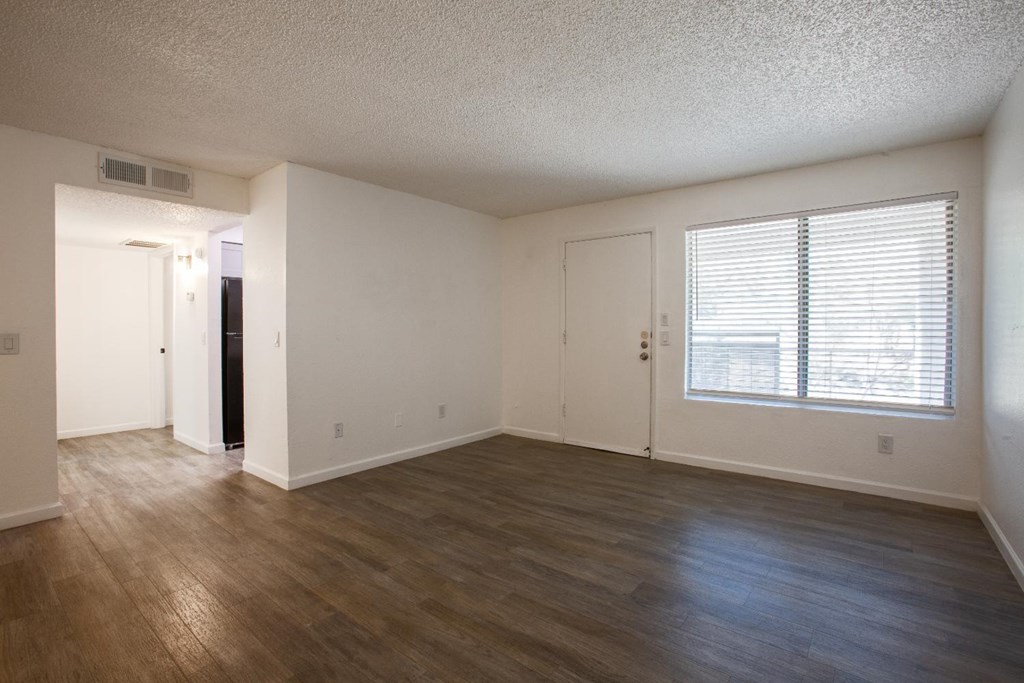 A room with wooden floors and white walls.