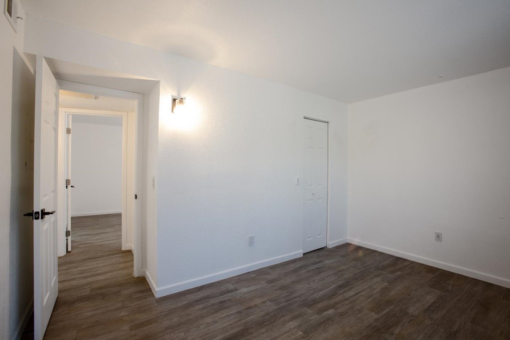A room with a wooden floor and white walls.