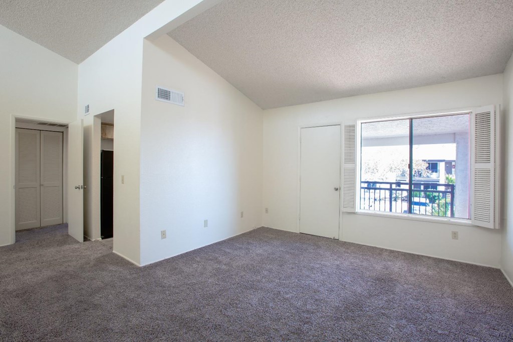 A room with white walls and a carpeted floor.