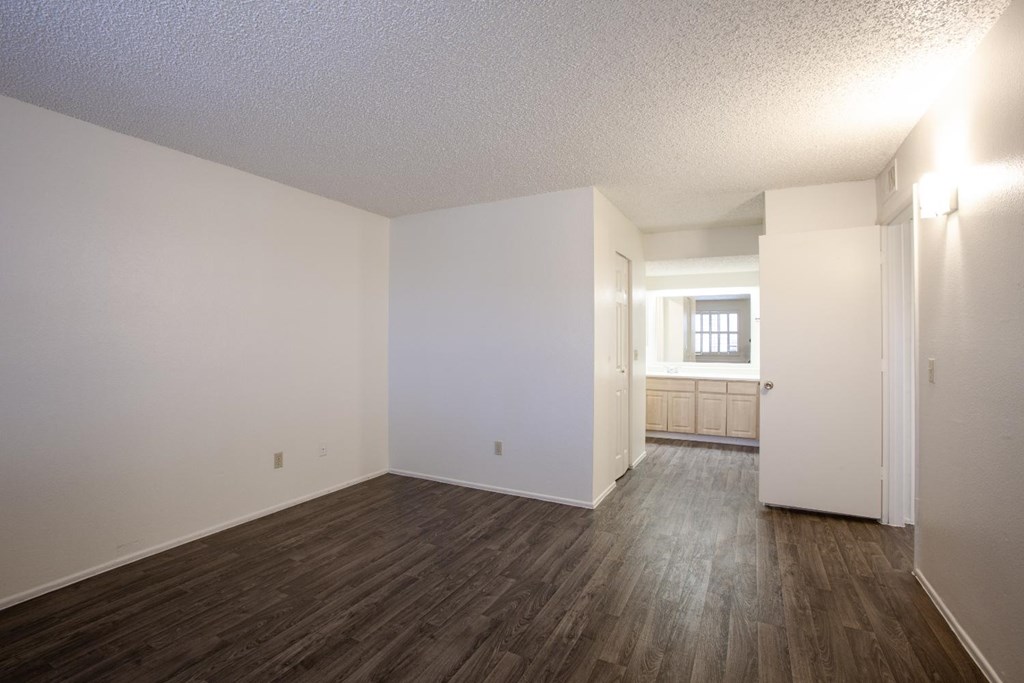 A room with wooden floors and white walls.