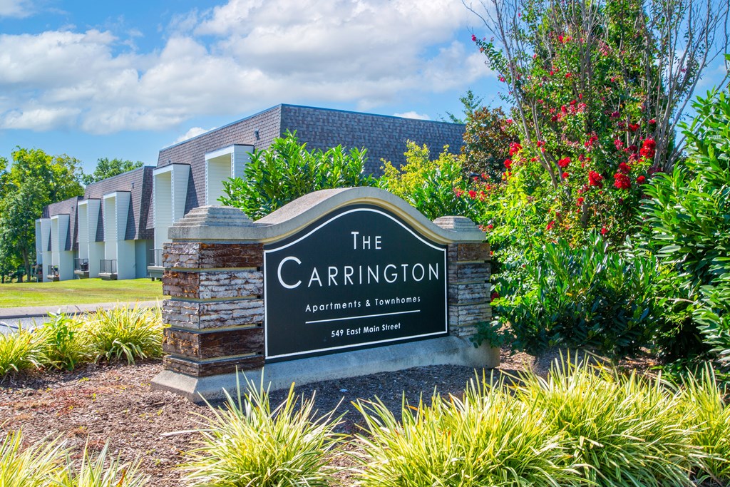 The Carrington Apartments sign in front of a building.