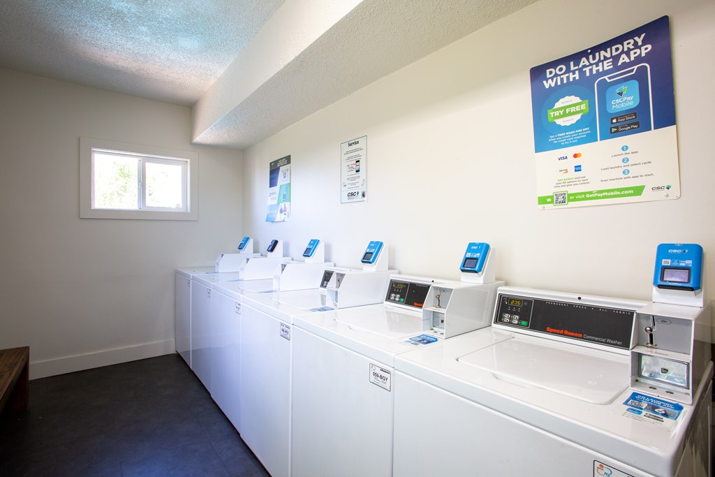A laundromat with a sign that says "Do Laundry with the App".
