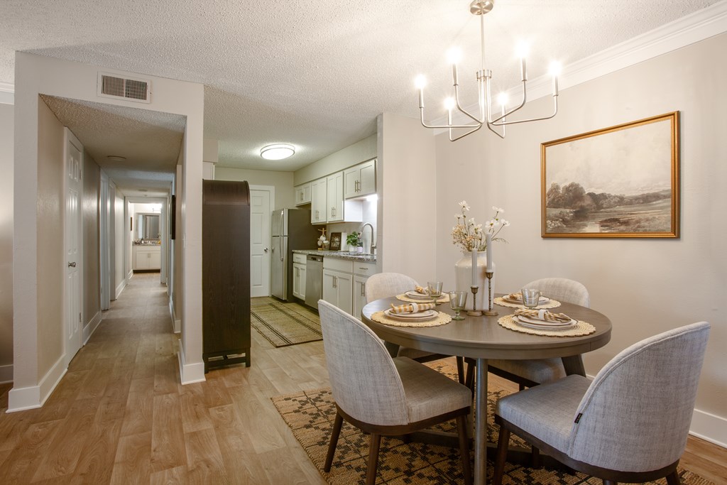 A dining room with a table set for two.