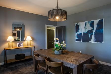 A dining room with a wooden table and chairs.