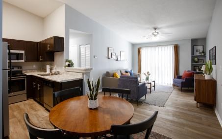 A modern kitchen with a dining table and chairs.