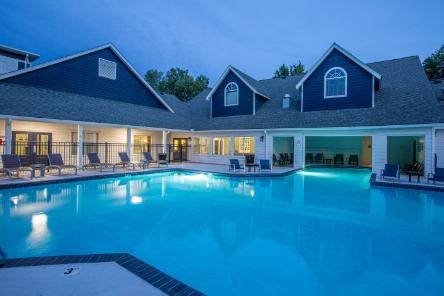 A large house with a swimming pool in the backyard.