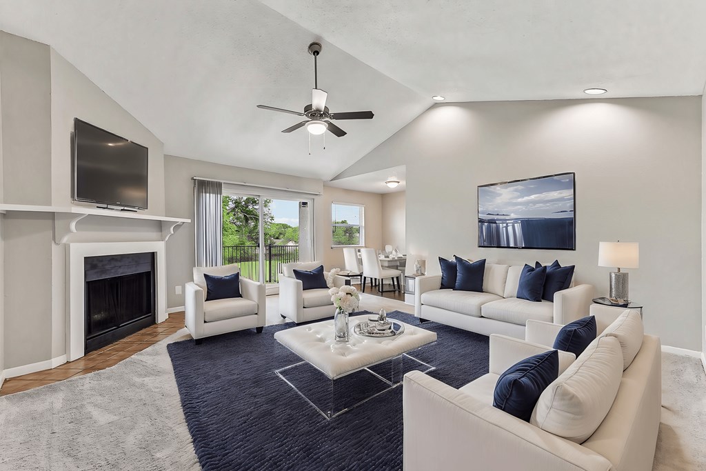 A living room with a fireplace and a television.