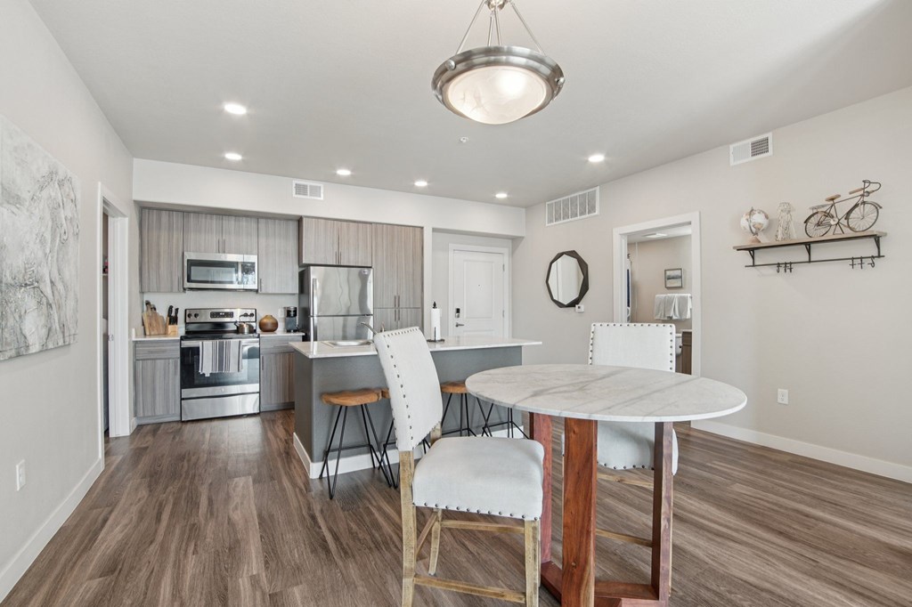 A modern kitchen with a dining table and chairs.