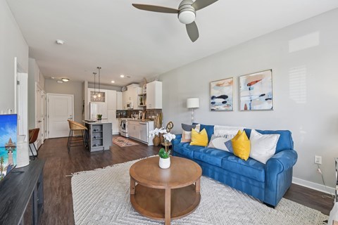 A living room with a blue couch and a coffee table.