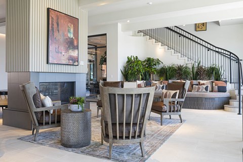 A living room with a fireplace and a painting on the wall.