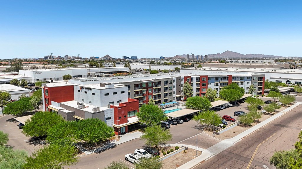 A large multi-story building with a parking lot in front.
