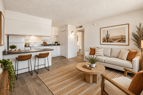 A modern kitchen with a bar stool and a dining table.