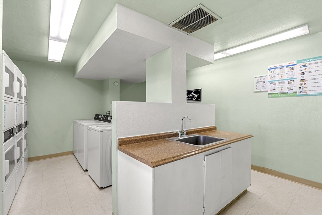 A kitchen with green walls and white appliances.