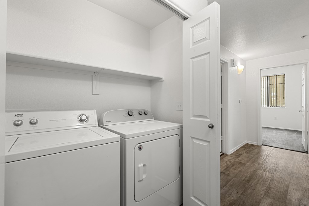 A small laundry room with a washer and dryer.