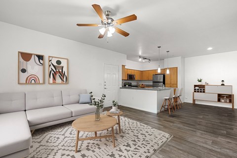 A living room with a white couch and a wooden coffee table.