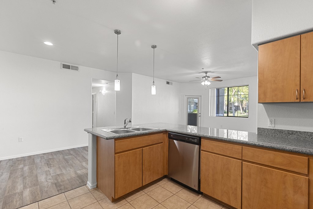 A kitchen with wooden cabinets and a granite countertop.