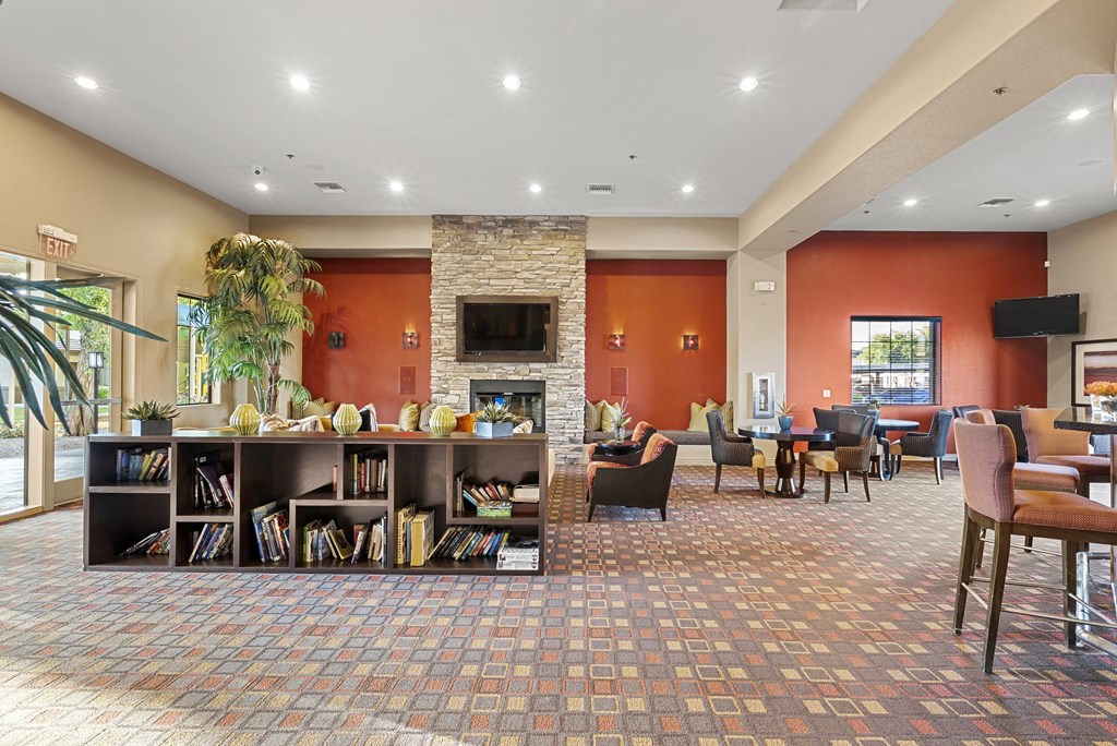 A room with a fireplace and a bookshelf.