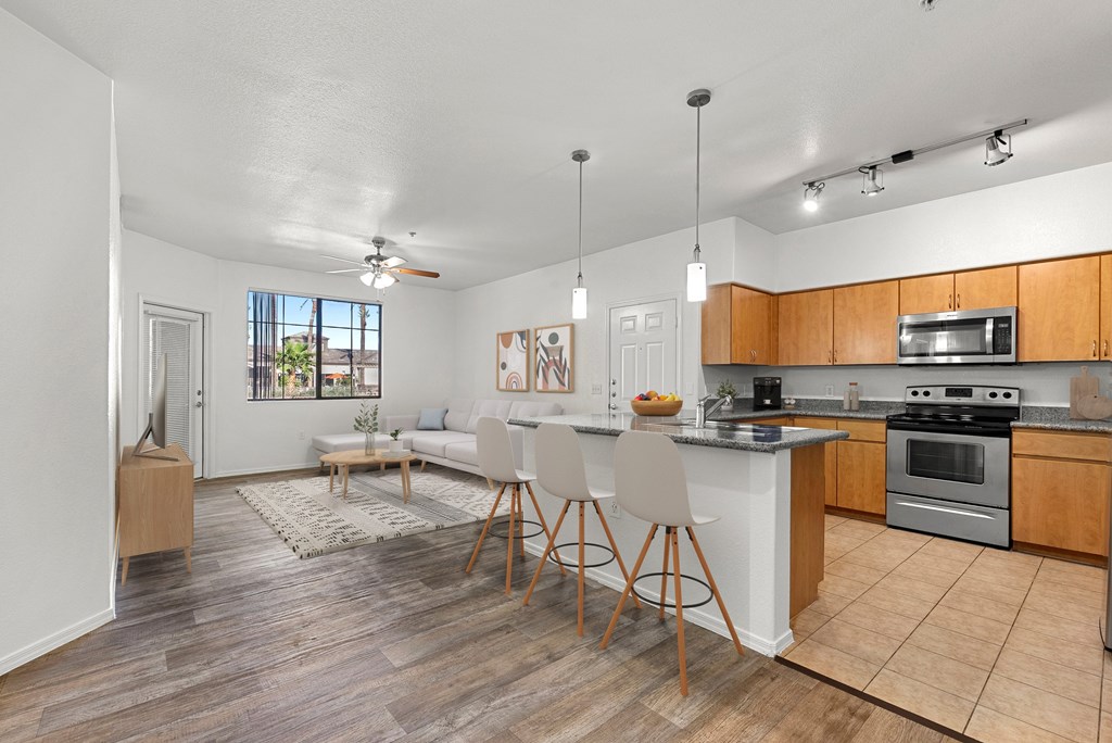 A kitchen with a dining table and chairs in the middle of the room.