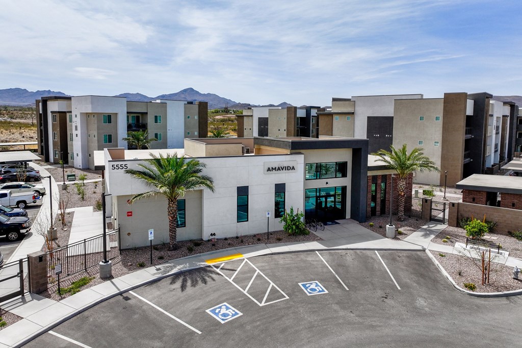 A parking lot in front of a building with the number 5555 on it.