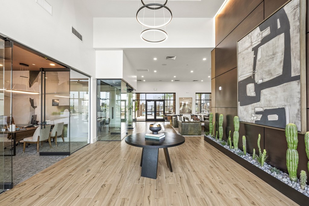 A modern dining room with a glass table and chairs.