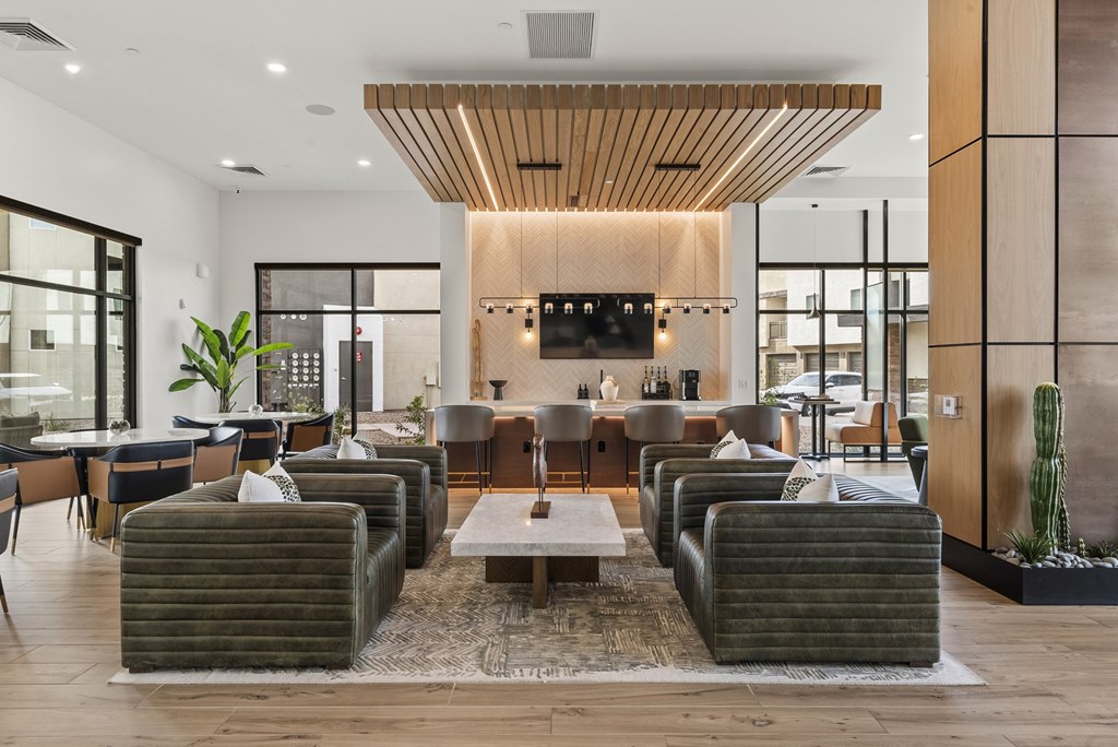 A modern living room with a large sectional sofa and a coffee table.