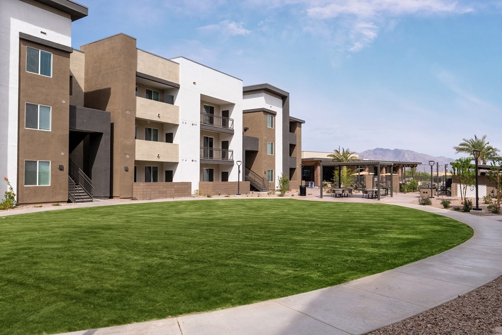 A modern building with a green lawn in front.