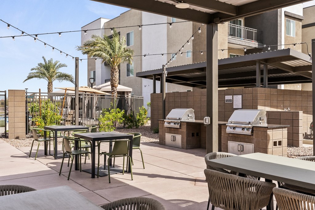 A patio with a table and chairs under a roof.