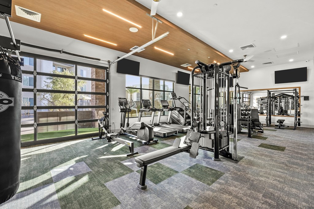 A gym with a variety of equipment including a punching bag.
