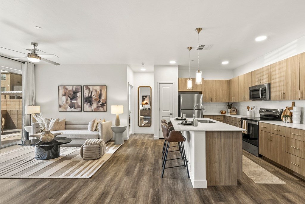 A modern kitchen with a dining area and a living room.