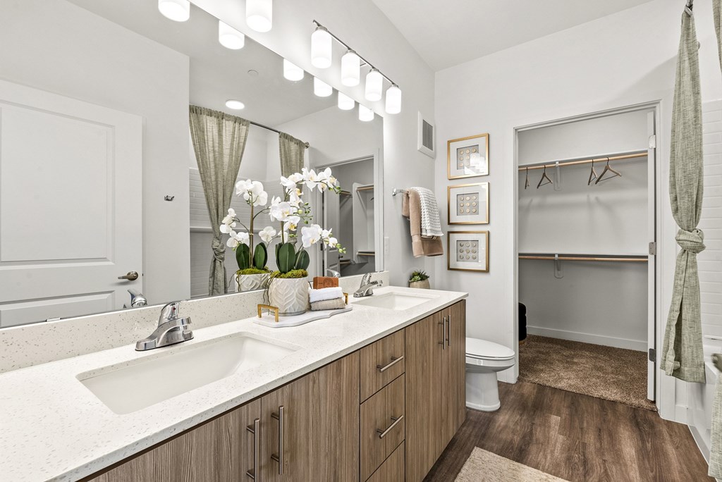 A bathroom with a white sink and a white toilet.