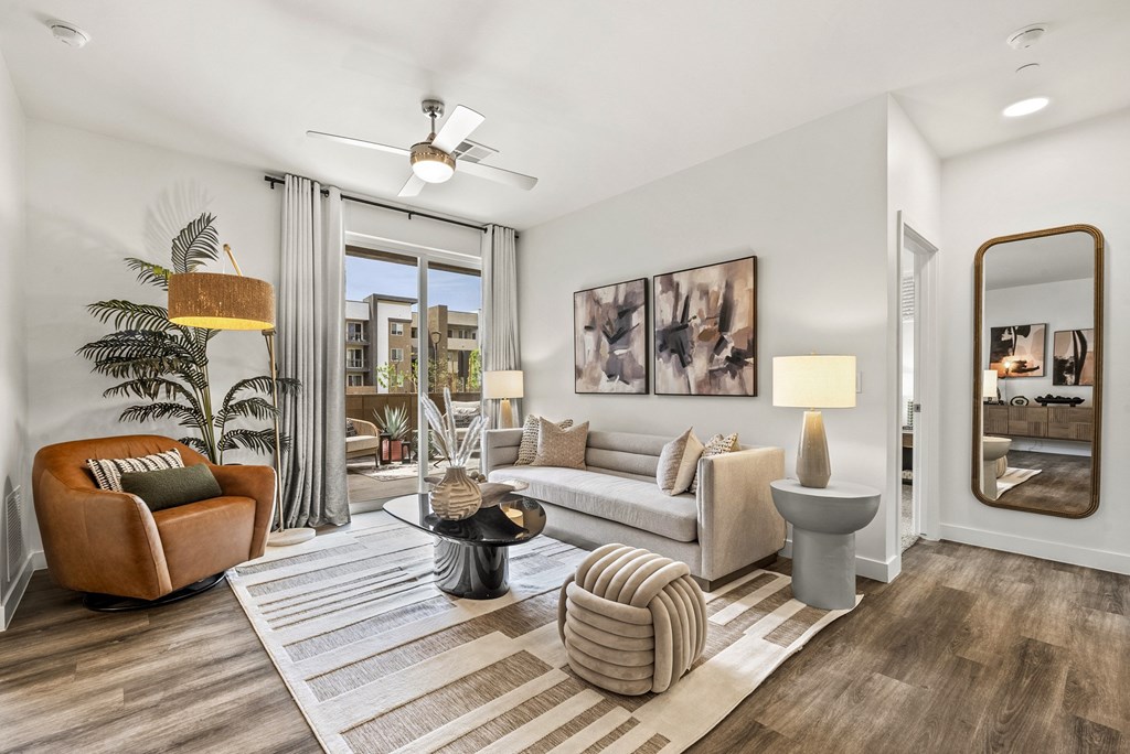A living room with a brown chair and a white couch.
