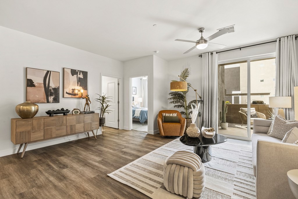 A modern living room with a wooden floor and furniture.