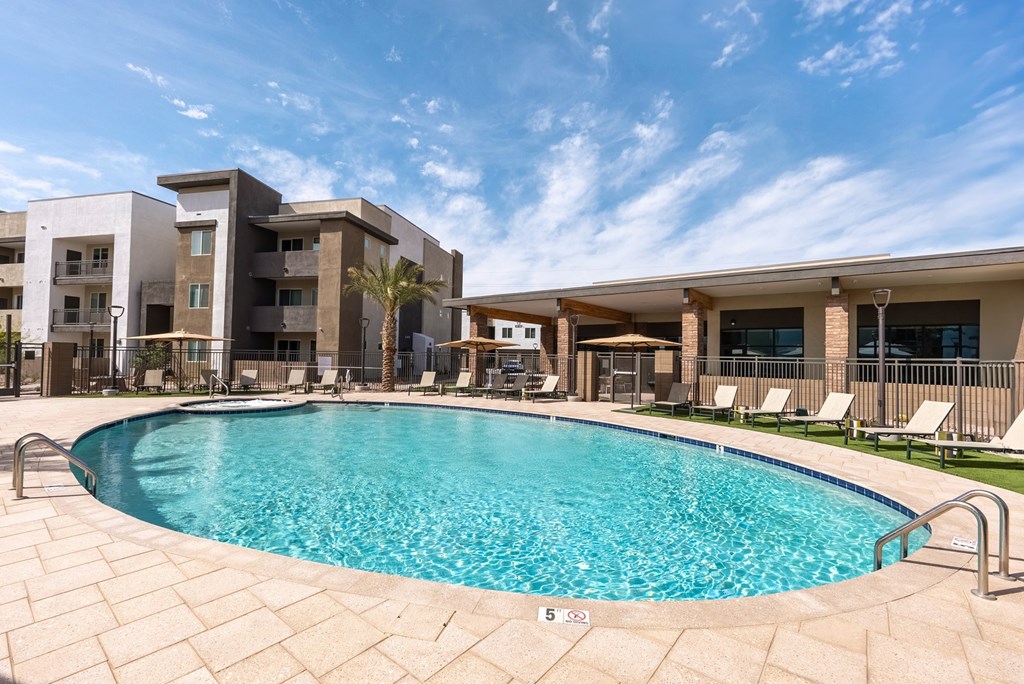 A swimming pool in front of apartment buildings.